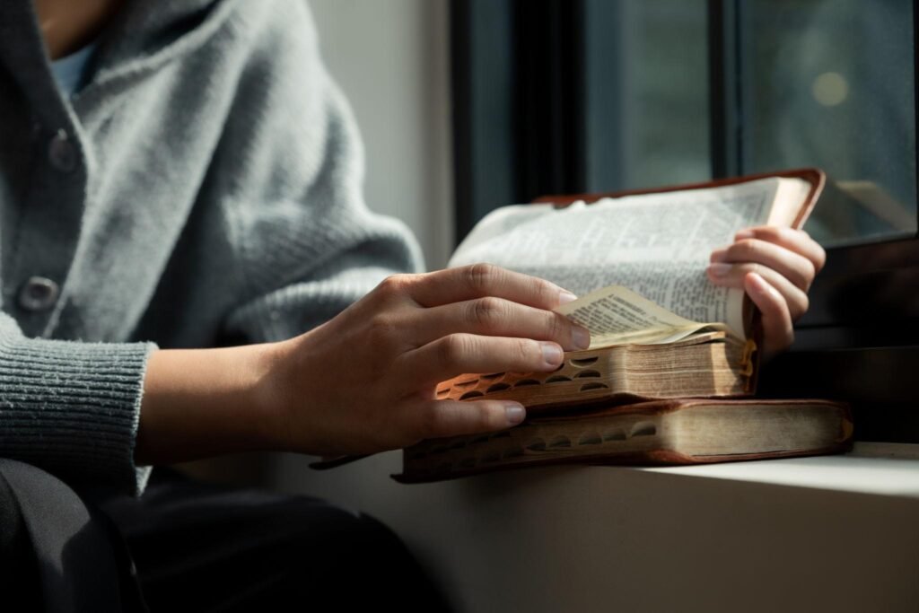 Open Bible and prayer journal illustrating daily Christian devotion.