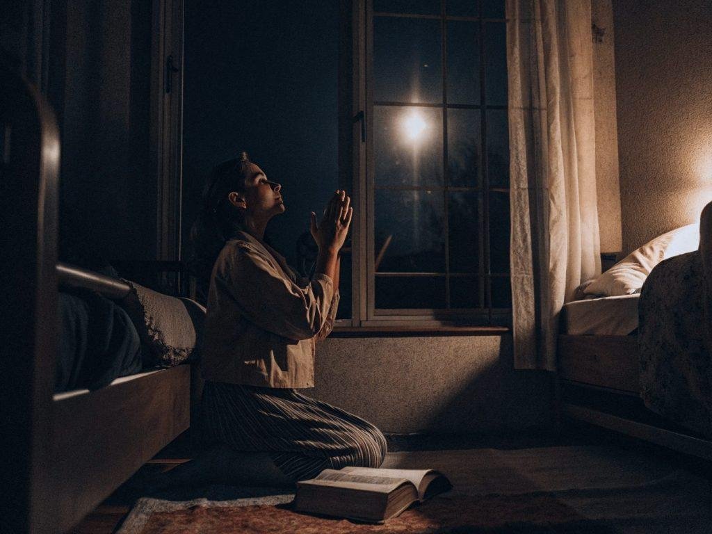Christian woman offering a night prayer